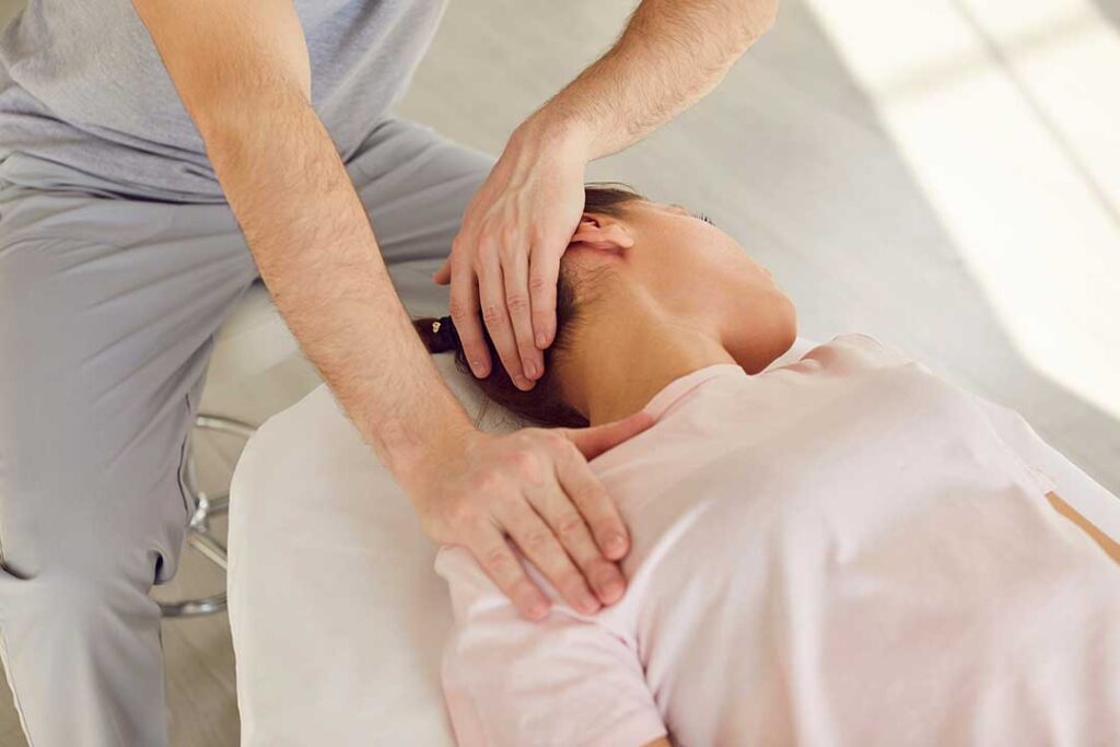 A chiropractor discusses a wellness plan with a patient in a bright, home-like consultation room.