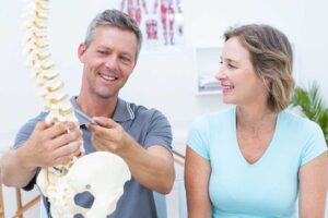 Athlete completing a controlled core exercise on a gym mat beside sports equipment.