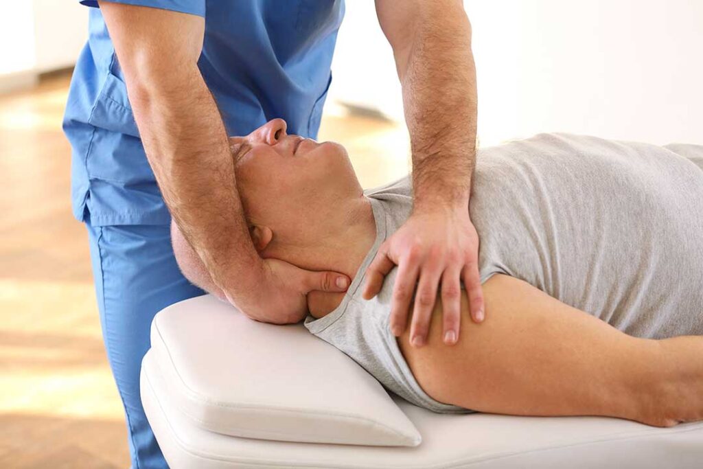 Person resting comfortably in bed after gentle back care, with a pillow supporting the knees and soft morning light.